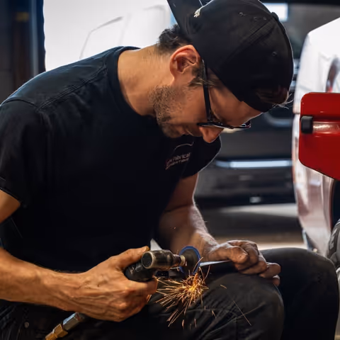 Dan using grinder with sparks during rust repair